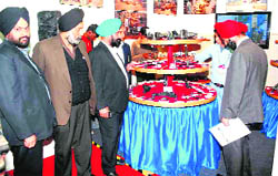 Visitors inspect the products at a stall at an industrial expo in Haridwar on Friday. 