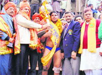 Wrestler Bagga of Amritsar being presented the silver gurj in Reasi districtin Jammu on Friday. 