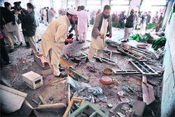 Security personnel investigate the blast site in Nowshera 