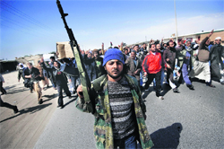 Anti-government activists raise slogans against Muammer Gaddafi during the funeral procession of those killed in violence in Ajdabiya, Benghazi.