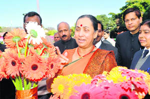 Uttarakhand Governor Margaret Alva looks at flowers after inaugurating the Basantotsav at Raj Bhawan 