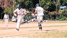Batsmen cross over for a run during a match of the Uttarakhand Twenty20 Big Bash in Dehradun on Saturday.