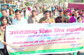 State Shiksha Mitras take out a rally in support of their demands in Dehradun on Saturday.