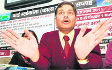 Eye specialist Dr Dinesh Sharma addresses a press conference in Dehradun on Saturday. 