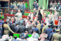 Legislators of opposition parties shout slogans against the state government in the Legislative Assembly in Jammu on Saturday