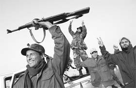 CELEBRATING VICTORY: Libyan rebels celebrate their victory against troops loyal to Muammar Gaddafi in the oil town of Ras Lanuf
