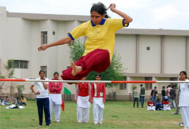 A student performs the high jump during the DAV College of Education athletic meet.