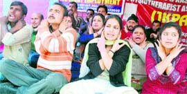 Members of the Jammu and Kashmir Physiotherapists Association stage a protest in Jammu on Sunday.