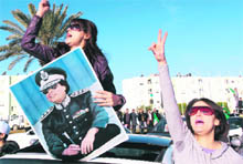 Supporters of Muammar Gaddafi chant slogans in central Tripoli on Sunday. 