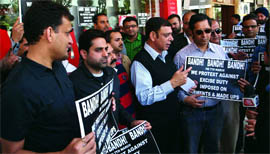Garment manufacturers and retailers hold placards during a protest against the proposed excise duty on garments in New Delhi on Monday.