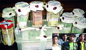 3 persons (inset) arrested for printing fake currency that was seized along with machine and tools at the police headquarters in New Delhi on Monday.