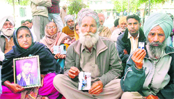 Family members of Indian youths struck up in Libya hold a protest in front of the District Administrative Complex in Jalandhar