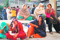 Members of the families of accident victims wail outside the mortuary of the Government Medical College and Hospital in Jammu on Monday.