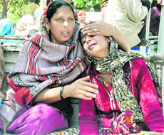 Grief-stricken family members of the deceased, Amarjit Kaur, in Chandigarh on Tuesday.