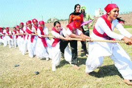 Girls participate in a tug-of-war event at the fifth Annual Athletics and Sports Meet at the Mata Sahib Kaur Khalsa Girls College of Education in Patiala on Tuesday.