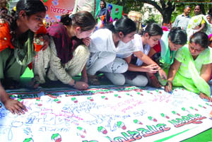 Activists of the Mahila Congress join the signature campaign supporting the Womens Reservation Bill near Parliament House in New Delhi on Tuesday.