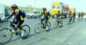 CROSSING BARRIERS: Students of Jamia Millia Islamia take part in 'Aman Caravan Cycle Rally-2011 from Wagah Border to their college in New Delhi on Tuesday. 