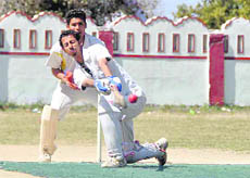   A batsman tries to pull a ball in a match of the Dehradun District Cricket League in Dehradun on Tuesday.