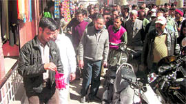 MC officials mark the encroached area at the Library Bazar in Mussoorie on Tuesday.