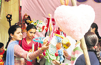 Students watch items on display during a function organised on the occasion of International Womens Day in Jammu on Tuesday. 