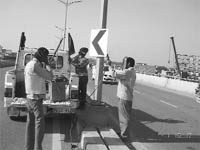A chevron indicating sharp turn on the Zirakpur flyover being installed. 