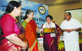 Union minister of information and broadcasting Ambika Soni presents an award to Shobha Mani on International Women's Day as part of centenary celebrations of the civil aviation in India, in New Delhi