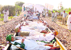 Activists of the Jat Aarakshan Sangharsh Samiti block a rail track at Mayyar village in Hisar 