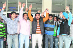 Activists of the National Secular Forum protest in support of their demands in front of the main library of University of Jammu on Wednesday. 