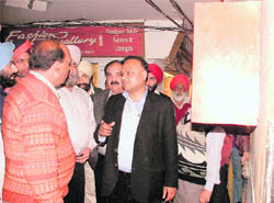 MC Commissioner AK Sinha interacts with shopkeepers at the AC Market in Ludhiana.