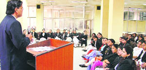 Sessions Judge SP Bangarh addresses woman lawyers at the district courts complex in Ludhiana on Tuesday.
