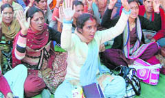 Shiksha Mitras stage a dharna in Dehradun on Wednesday.