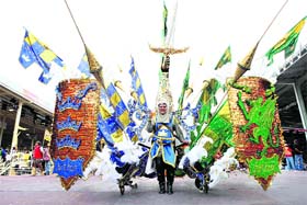FESTIVE COLOURS: A participant from the The Warrior Within band takes part in a parade at Queens Park Savannah in Port of Spain
