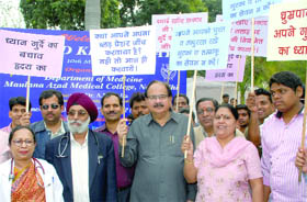 Health minister A.K.Walia and staff of Maulana Azad Medical Callege hold placards during a walk for health on the occasion of World Kidney Day at the college in New Delhi on Thursday. 