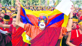 Tibetan monks protest against China at the Gandhi Park, Dehradun, on Thursday.