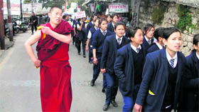 A monk accompanies a rally organised by Tibetans to mark the 52nd National Uprising against the Chinese regime in Mussoorie on Thursday.