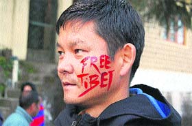 A youth takes part in a protest at McLeodganj