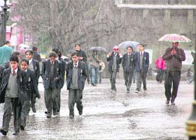 Students caught in a sudden hailstorm and rain in Shimla
