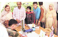 An Army doctor examines villagers at a medical camp at Pargwal near Jammu