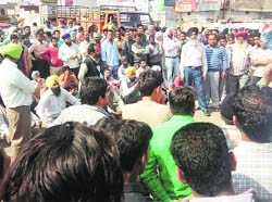 Villagers stage a protest on the Chandigarh-Ludhiana road at Khamano on Thursday.