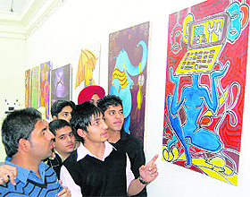 Students of Hindu College explain their paintings to a visitor at Thakar Singh Art Gallery in Amritsar. 