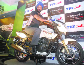 HS Goindi, President Marketing, TVS Motor Company, poses with the Apache RTR 180 ABS(Anti-lock Braking System) , during its launch, in New Delhi on Friday. The TVS Apache RTR 180 ABS comes in the spectacular white color with differentiating orange decals and it's priced Rs. 78,880/- (Ex-showroom).