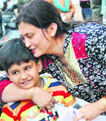 Princy, a parent from Panchkula, hugs her son on hearing the news of his selection in a school.