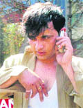 Injured driver Sanjay Kumar talks on a mobile phone at the PGI roundabout in Chandigarh on Friday. 