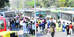Harassed commuters gather around haphazardly parked buses at a PGI bus stop following a scuffle between a Panjab University student and a CTU bus driver in Chandigarh on Friday. 