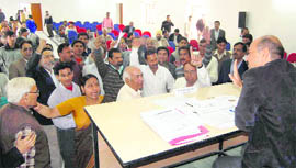 Acting Chairman of the Uttarakhand Electricity Regulatory Commission Anand Kumar listens to the objections of people at a public hearing in Dehradun on Friday.
