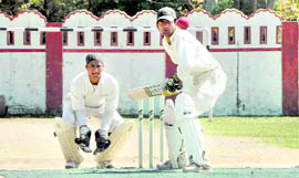 A batsman eyes the ball during a match in the Dehradun District Cricket League at the Survey Stadium in Dehradun on Friday.
