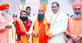 Saints and political leaders at the death anniversary programme of religious guru and former MLA Acharya Jagdish Muni in Haridwar on Friday.