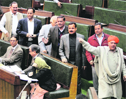 Legislators of the BJP and the Panthers Party shout slogans in the Legislative Assembly in Jammu