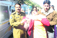 CRPF personnel help in shifting an injured woman to hospital in Doda district 