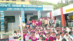 Army officers with staff and students of Government High School, Dhandal, in Udhampur district.